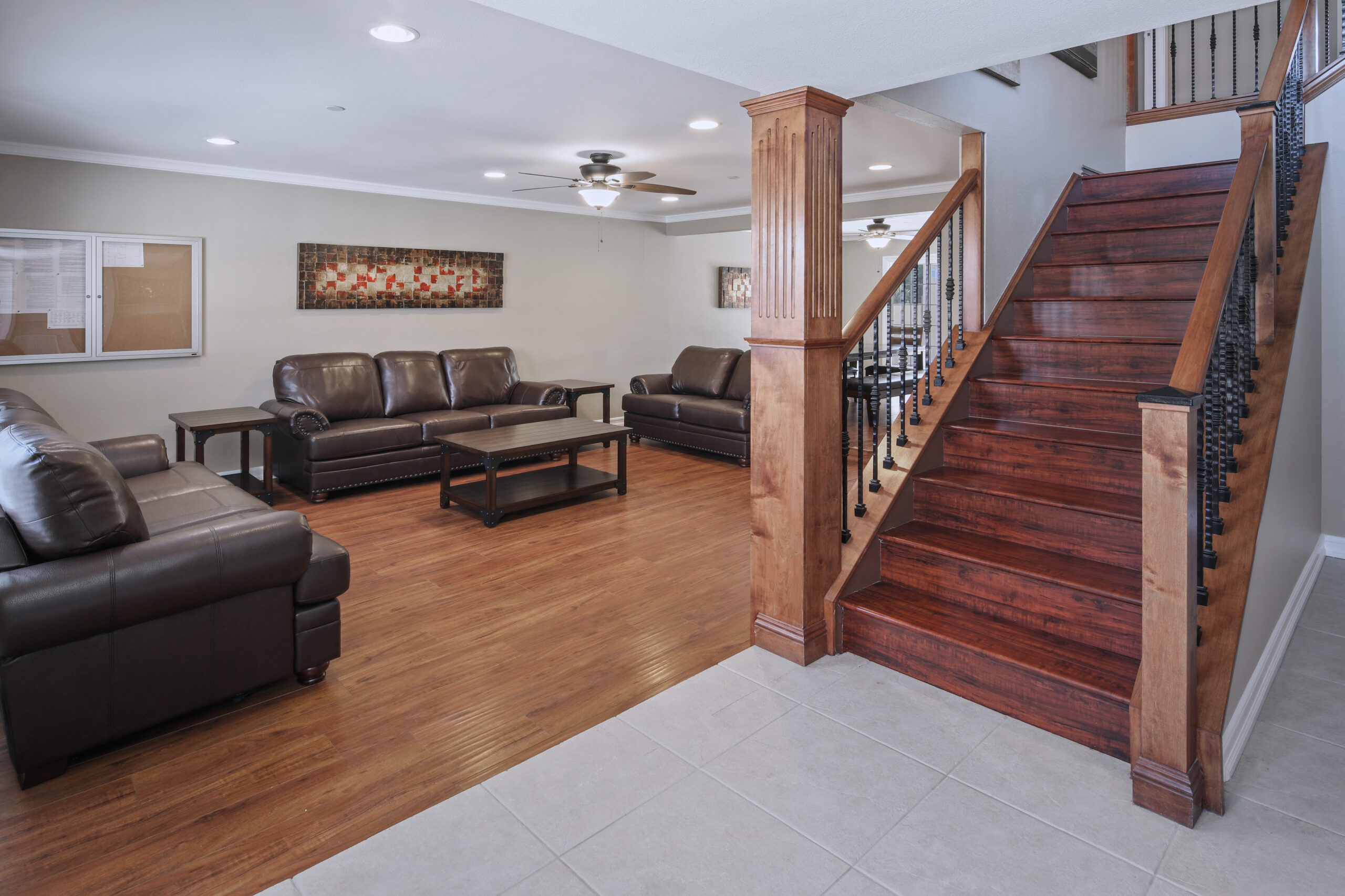 Brown chairs and coffee table, brown staircase leading up in young adult substance abuse program