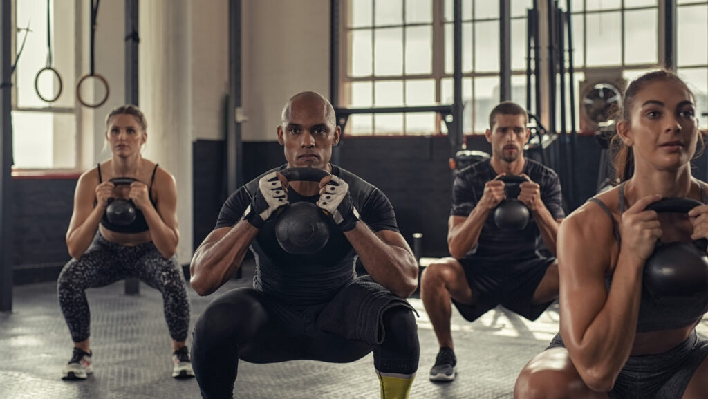 A group of men and women in a fitness class using Adderall to help them improve their physical abilities to get stronger at the gym.