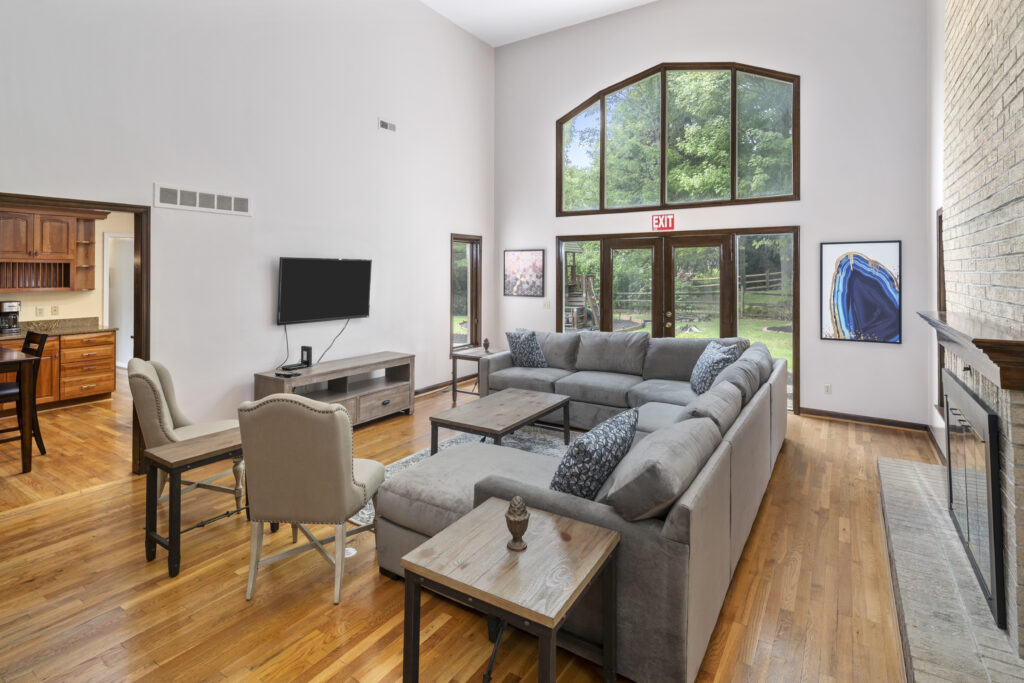 Gray couches with brown coffee table facing a mounted TV