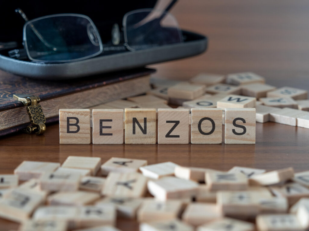 Block letters on a table spell out the word benzos.