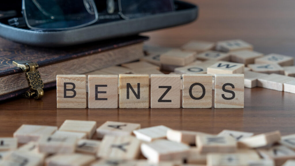 Block letters on a table spell out the word benzos.