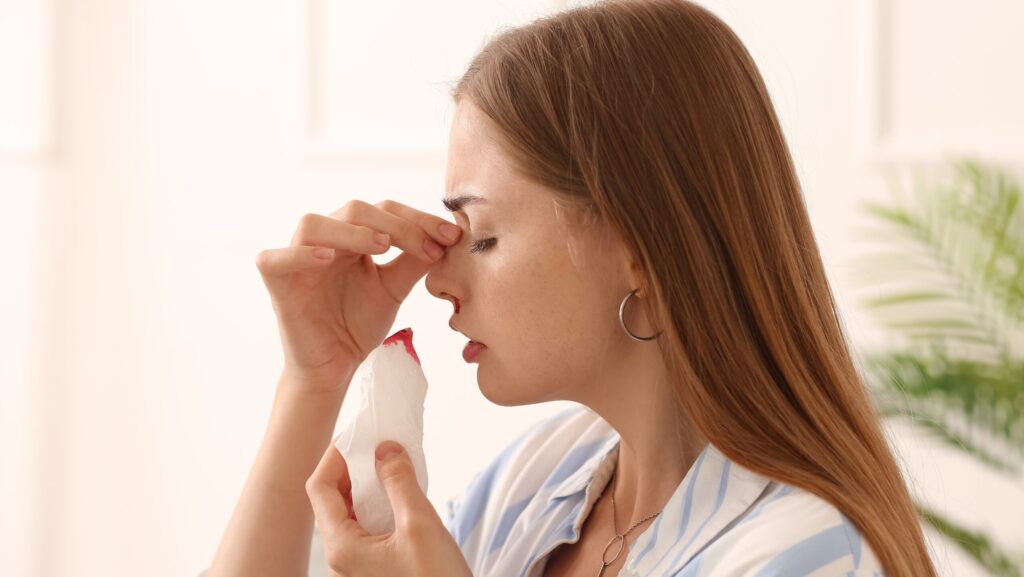 A young woman who abuses alcohol experiences alcohol induced nosebleeds.