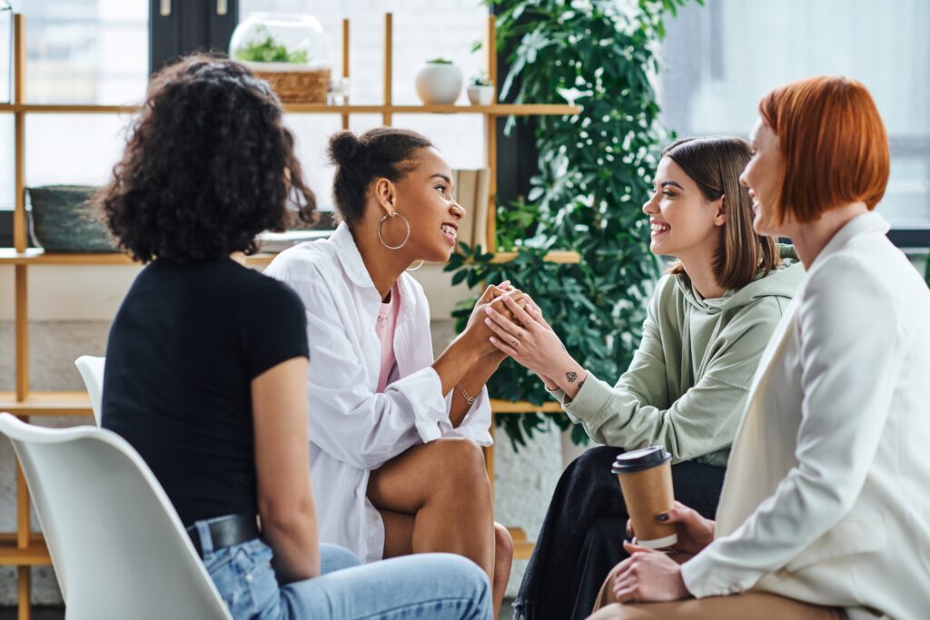 A group of four young women who attend a meeting for support for families of alcoholics.