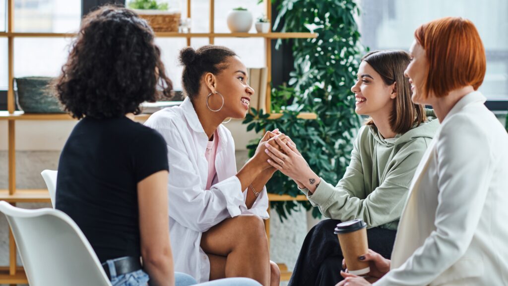 A group of four young women who attend a meeting for support for families of alcoholics.