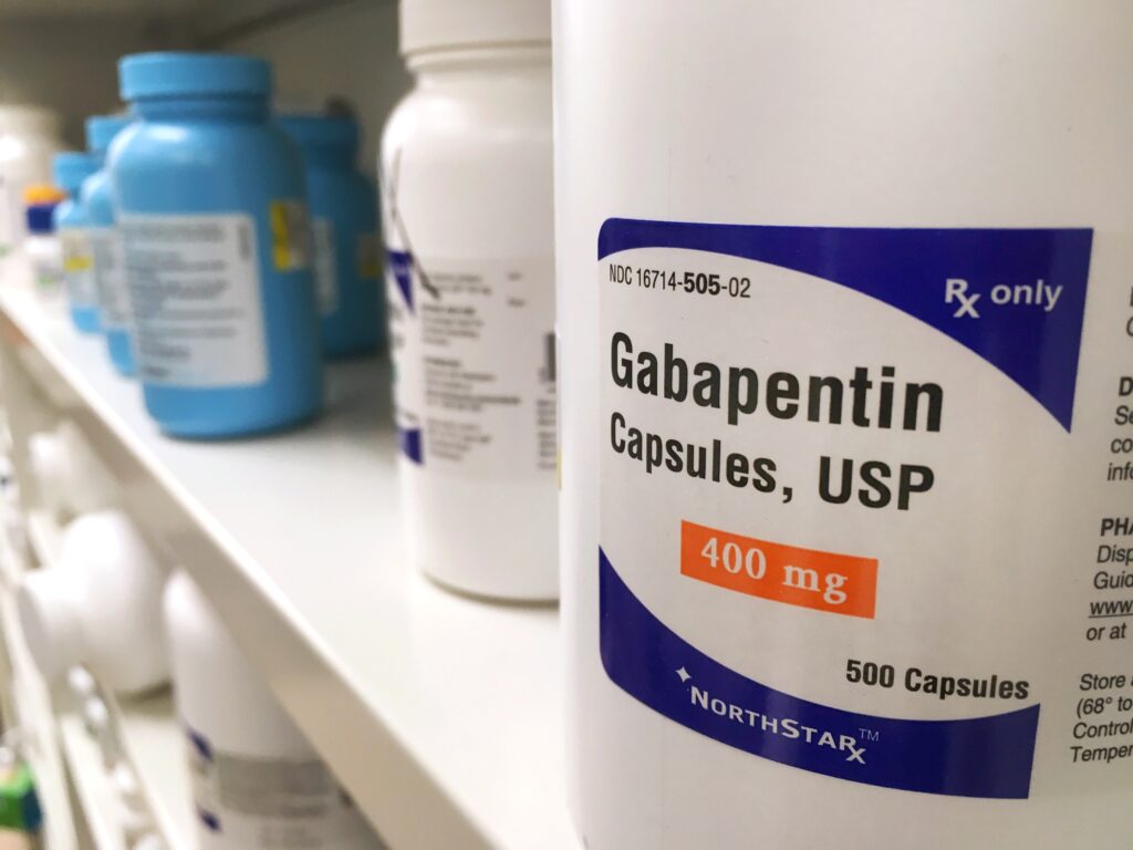 A bottle of gabapentin on a pharmacy shelf represents the rise in gabapentin abuse.