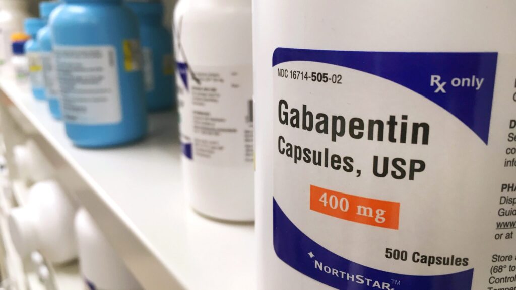 A bottle of gabapentin on a pharmacy shelf represents the rise in gabapentin abuse.